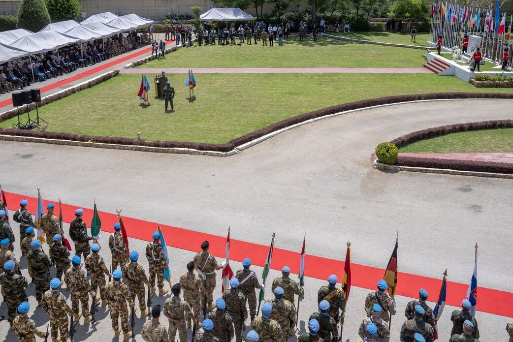Peacekeepers standing in a line are photographed from above.