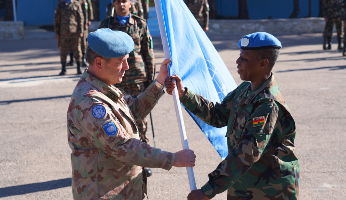 Maj Gen Asmah receiving the UN Flag from Maj Gen Gauchat