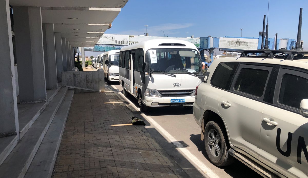 The convoy of buses at the arrival area in Damascus International Airport