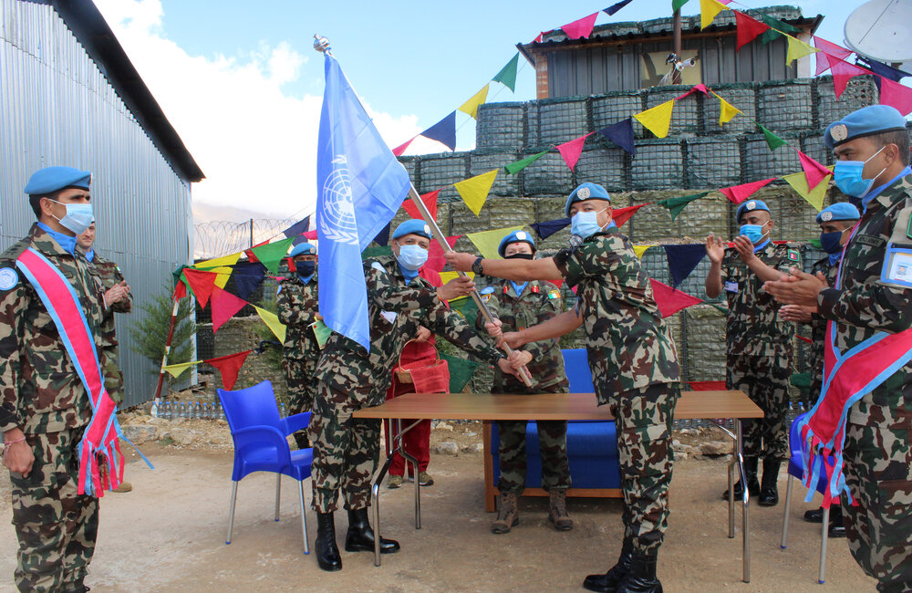 NEPCON COs ceremonially exchange the UN Flag to conclude the HOTO